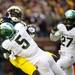 Michigan wide receiver Devin Gardner is unable to hold on to the ball as he is tackled by Michigan State cornerback Johnny Adams on Saturday. Daniel Brenner I AnnArbor.com